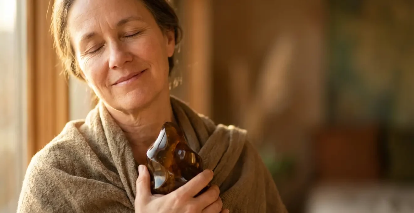 Persona en estado meditativo preparándose para sesión espiritual con objeto personal en sus manos